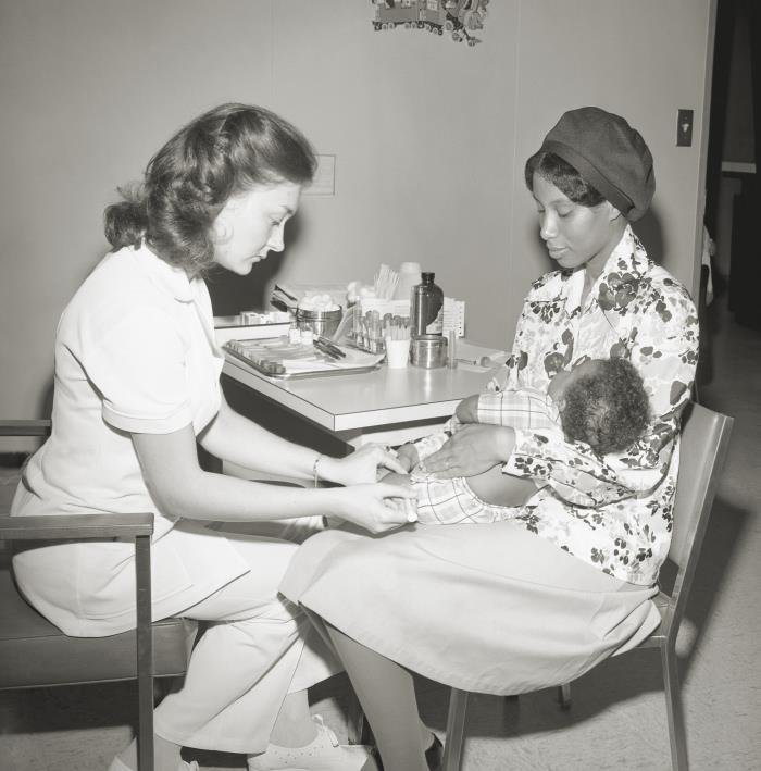 A mother and infant at a clinic for immunisation, representing the maternal and infant vaccination protected by the new WHO-prequalified RSV vaccine